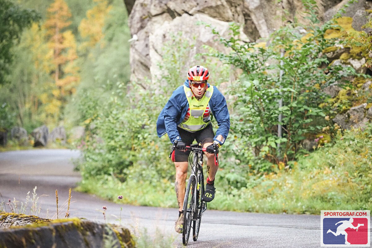 Charlie Sarmiento riding the rain-soaked bike course at Norseman Xtreme Triathlon